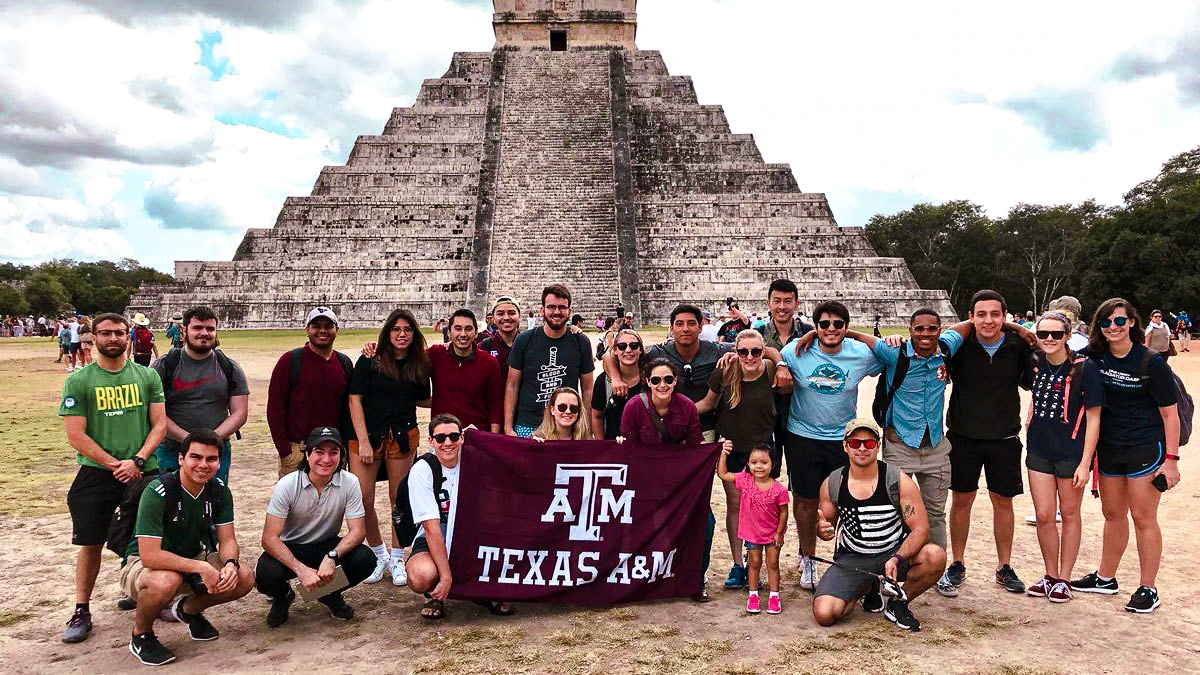 Anthropology students holding Texas A&amp;M flag