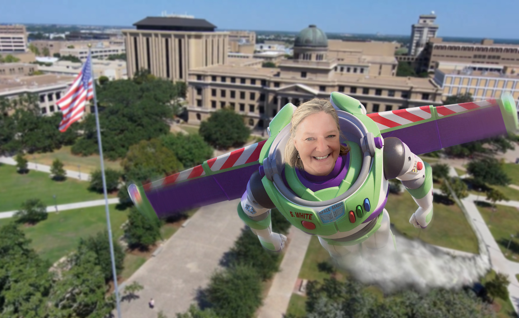 Sondra White dressed as Buzz Lightyear figure flying into the sky over the Academic building at Texas A&amp;M University