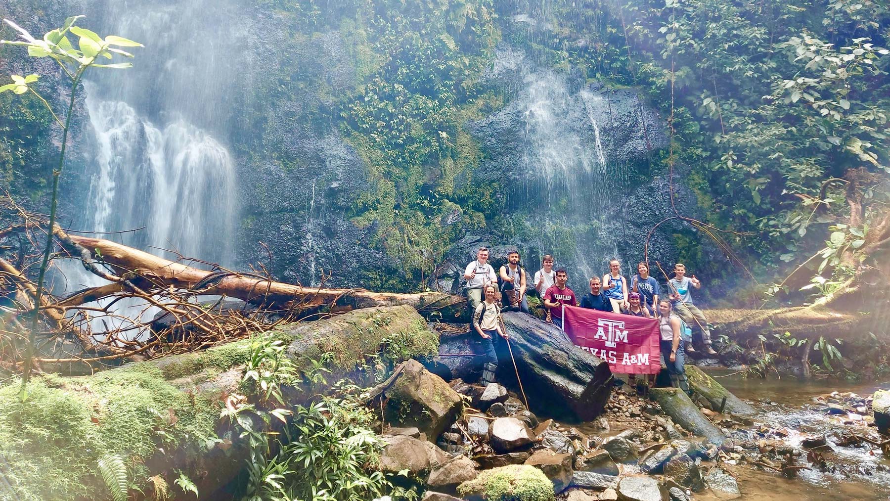 Texas A&amp;M students in front of a waterfall in Costa Rica