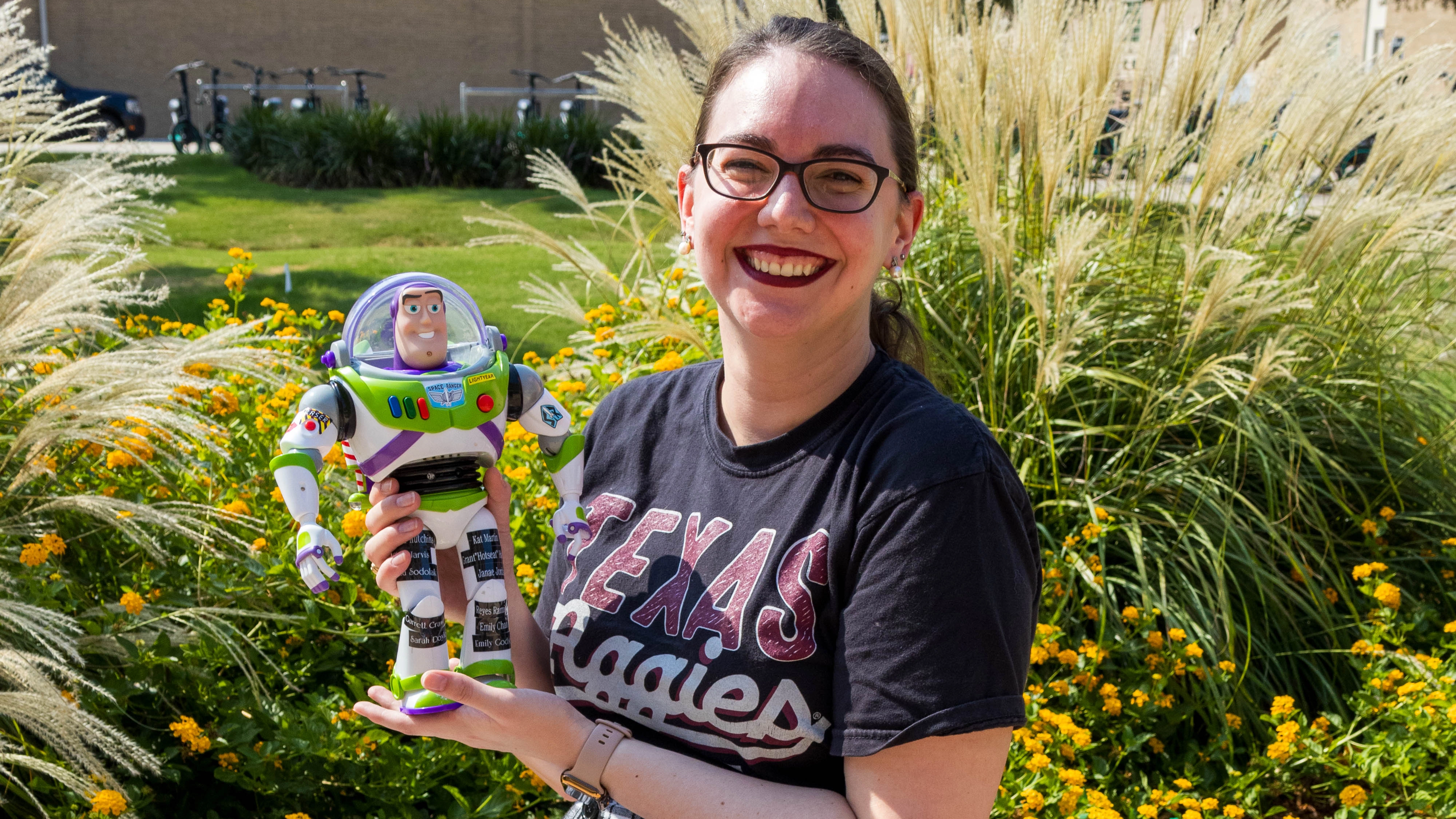 Graphic Designer Sarah Doyle holding a Buzz Lightyear action figure