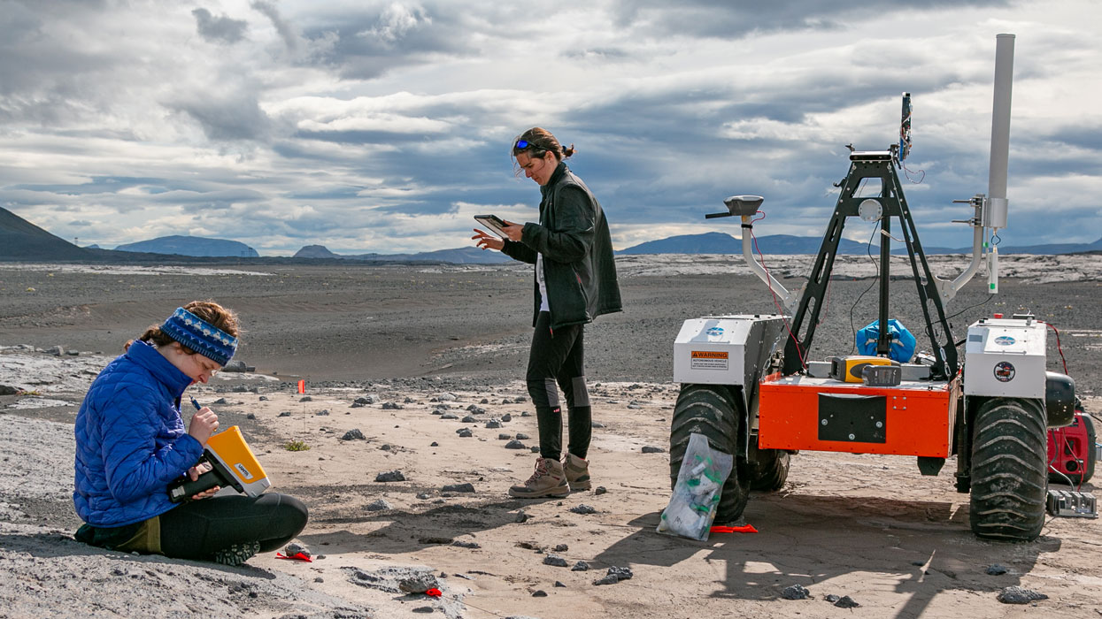Geology students doing research with a Mars rover in Iceland 