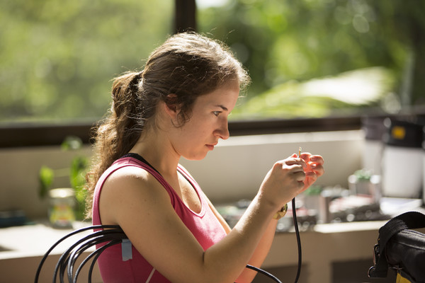 Student examining equipment wires 