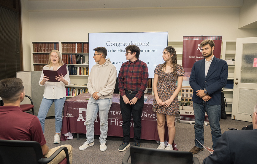 Phi Alpha Theta induction, Hannah Kalinkewicz inducts Gabriel MacMurray, Sebastian Miranda, Noelyn Lafferty, and Ethan Rhame.