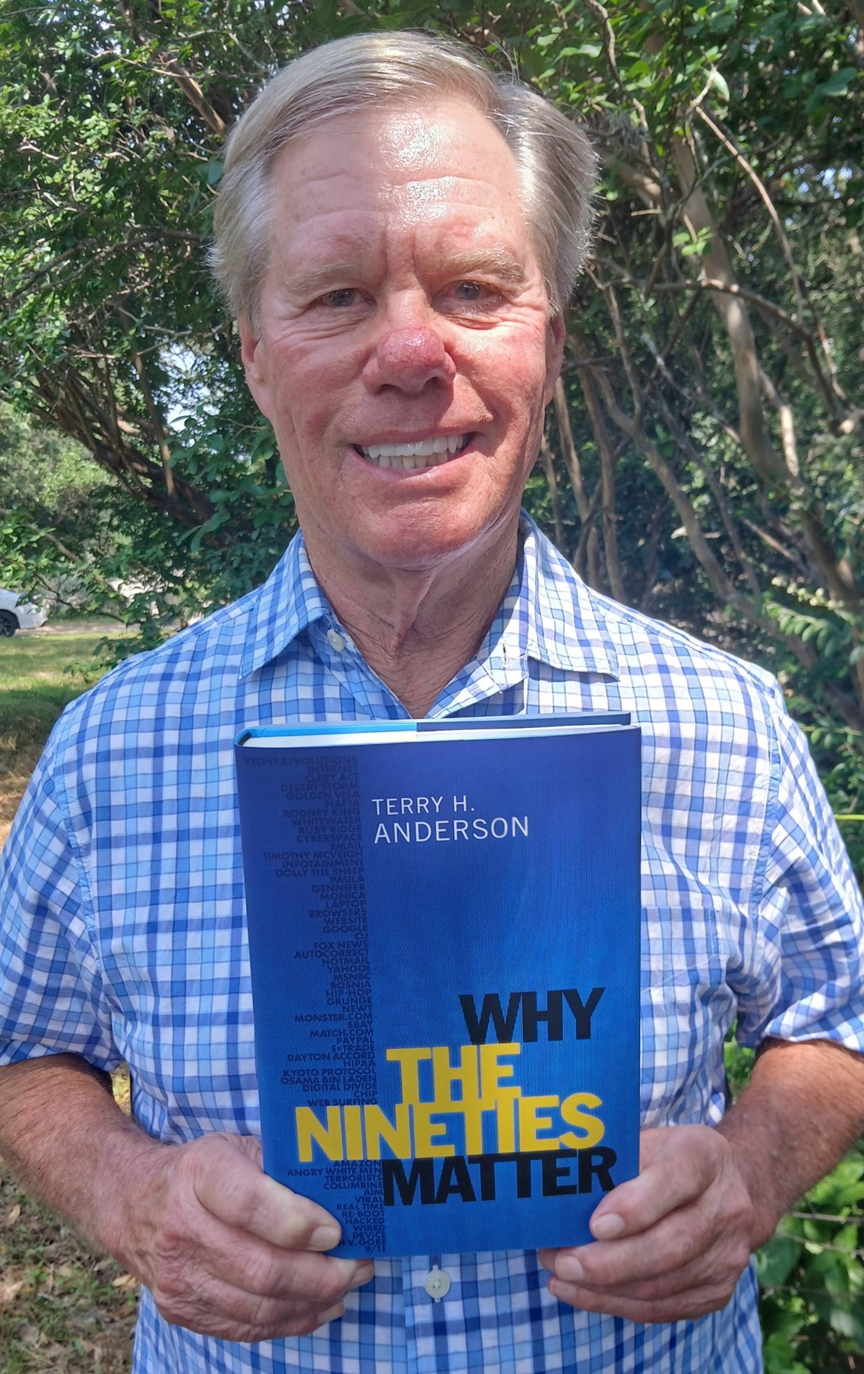 Dr. Terry Anderson holding his book Why the Nineties Matter.