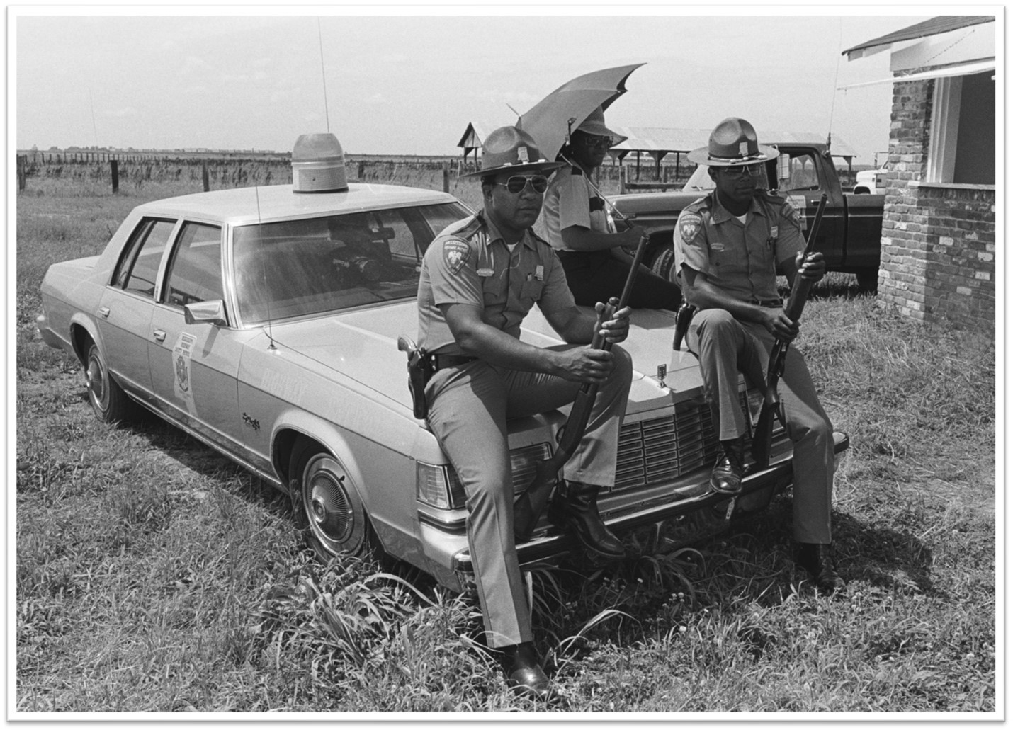 two state policemen watching on as the Blues artist B. B. King performs for prisoners at Parchman penitentiary in 1980