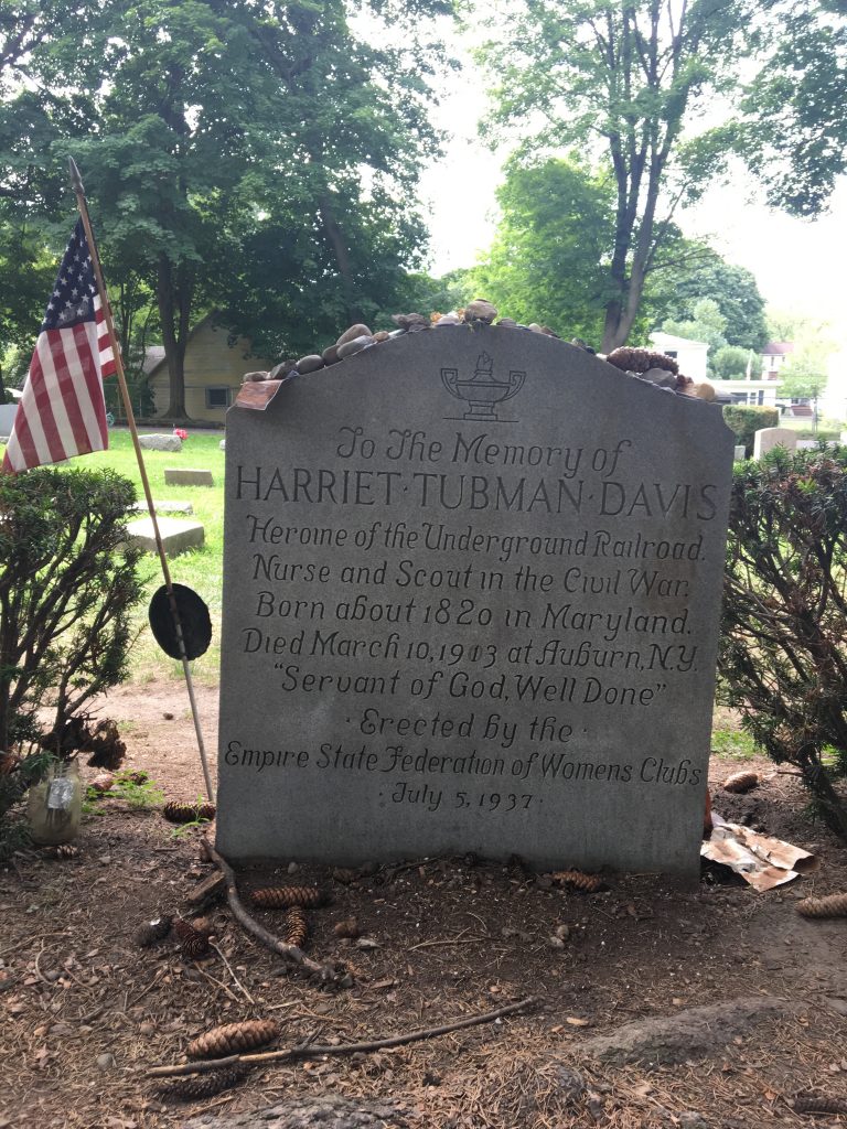 Harriet Tubman's grave with the tombstone reading, "To the Memory of Harriet Tubman Davis, Heroine of the Underground Railroad, Nurse, and Scout in the Civil War, Born about 1820 in Maryland, Died March 10, 1903 at Auburn, NY, "Servant of God Well Done," Greeted by the Empire State Federation of Women Clubs: July 5, 1937."
