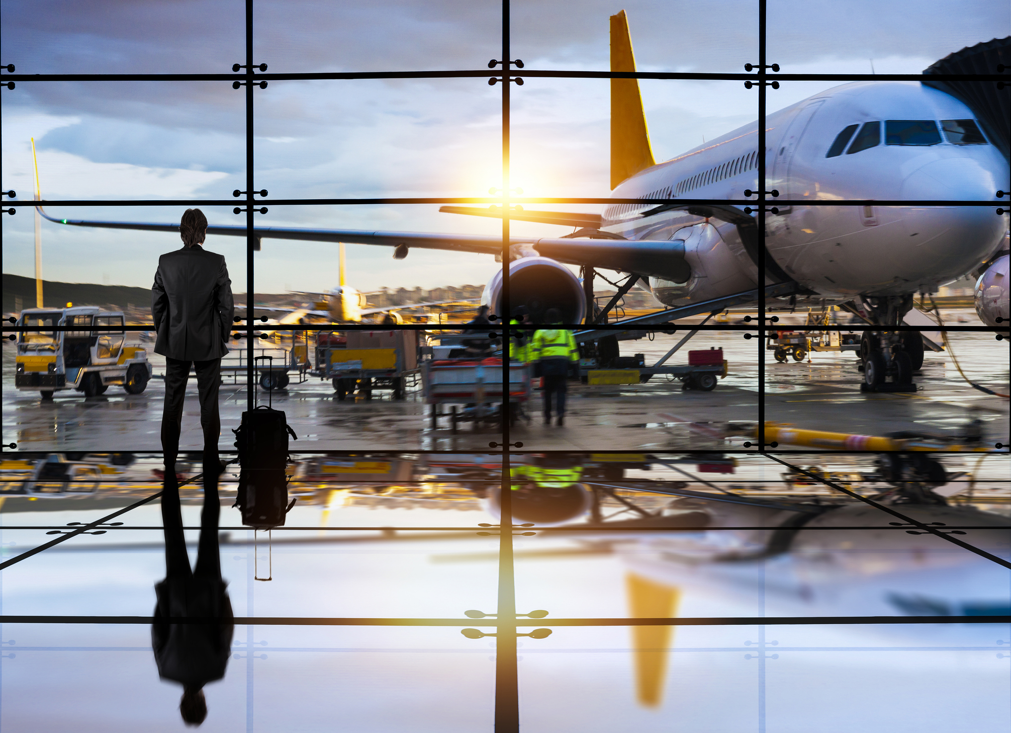 man at airport waiting for flight