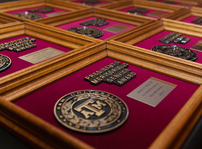 Close up of President's Meritorious Staff Award plaques displayed on a table