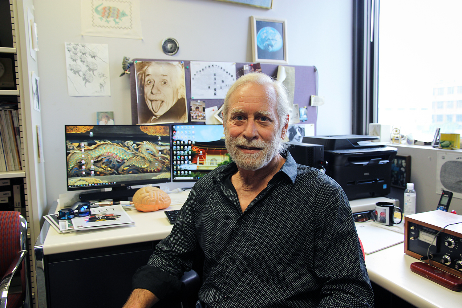 Texas A&amp;M psychology and brain sciences professor Steven Smith, sitting at his desk in his campus office