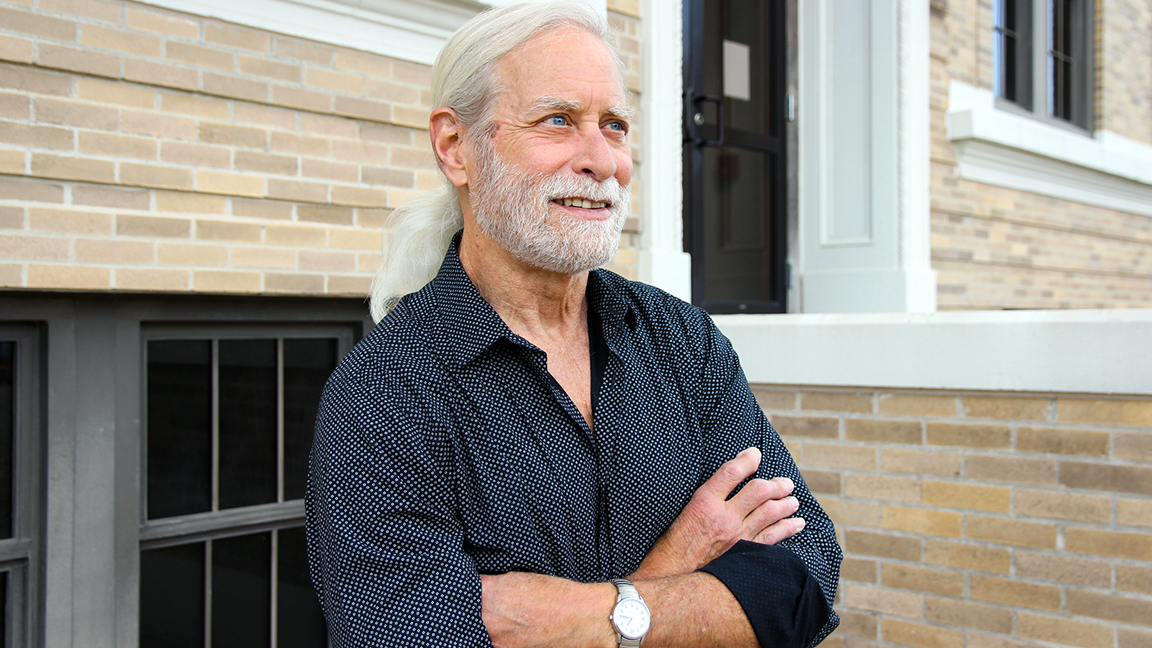 Texas A&amp;M psychology and brain sciences professor Steven Smith stands with his arms crossed outside the Psychology Building