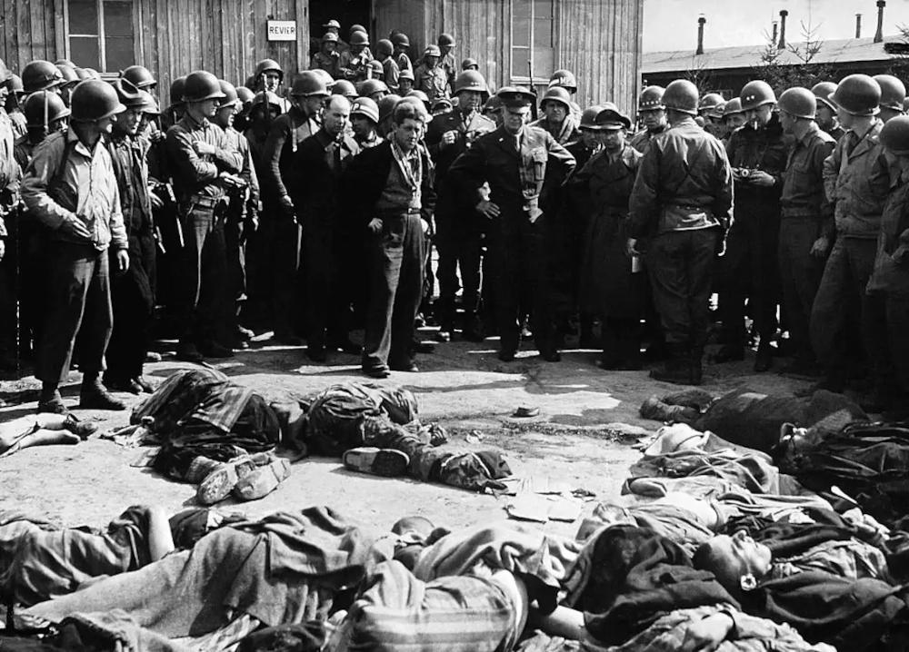 General Dwight D. Eisenhower and soldiers discover 70 prisoner bodies at the Ohrdruf concentration camp, near Buchenwald, who had been executed by the fleeing Nazis.