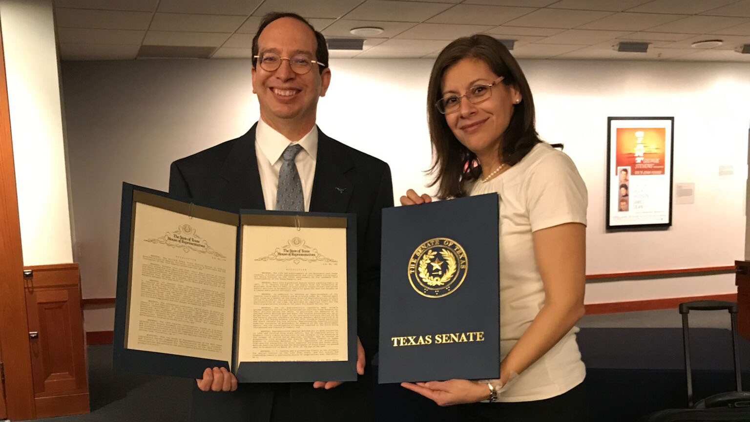 Hernández and Refusing to Forget's co-founder John Morán González hold the Texas senate resolution in February 2019.