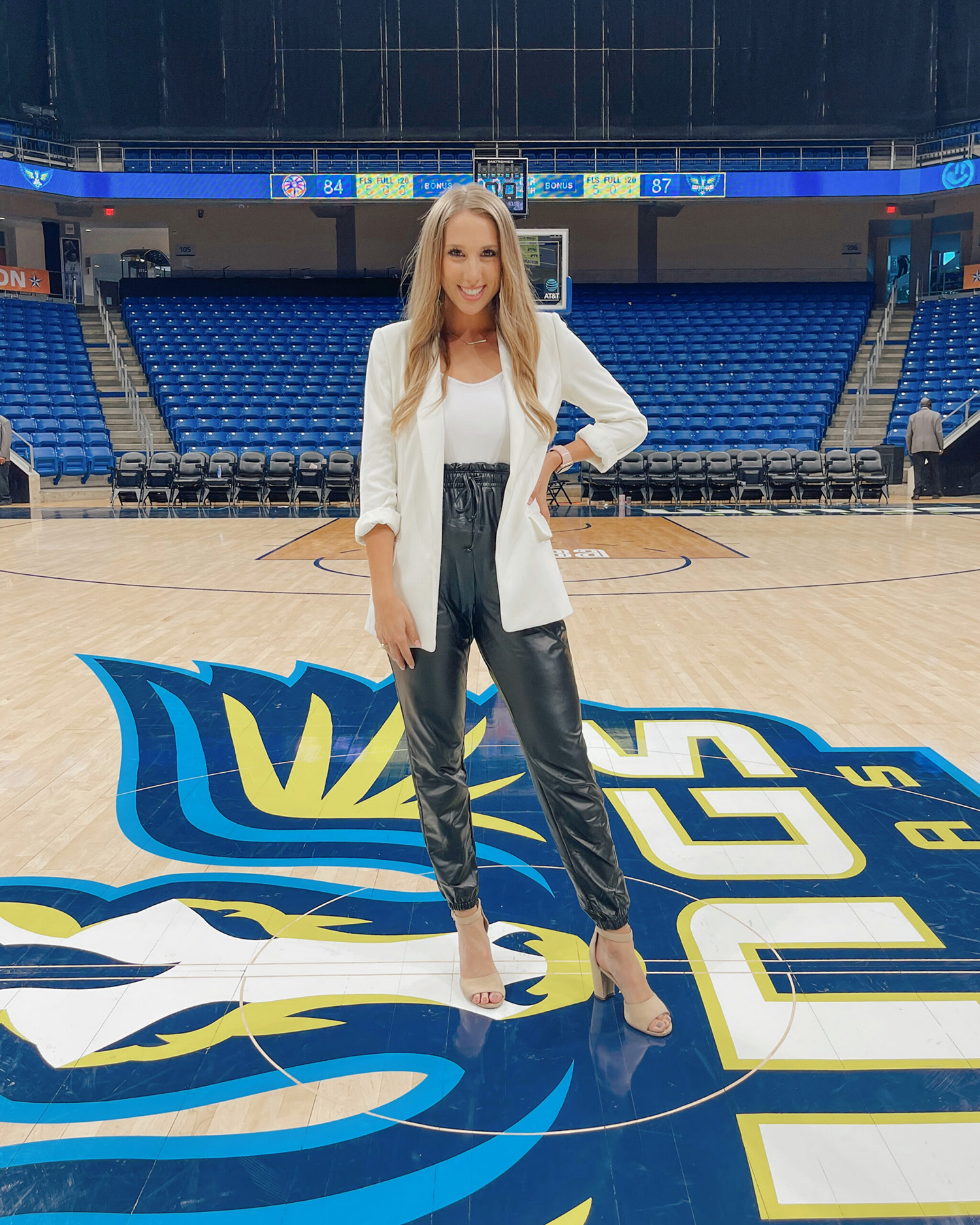 2019 Texas A&amp;M telecommunications graduate Lia Musgrave stands at center court prior to covering a Dallas Wings game,