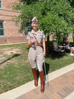 Texas A&amp;M senior Grace Vaughn flashes a gig 'em while posing in her Corps of Cadets uniform on the Quad