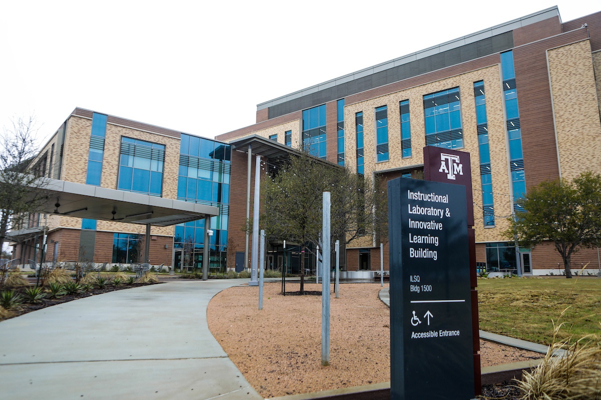 Exterior view of the Instructional Laboratory and Innovative Learning Building at Texas A&amp;M University showcasing the front lawn and outdoor study space located on the building’s south side