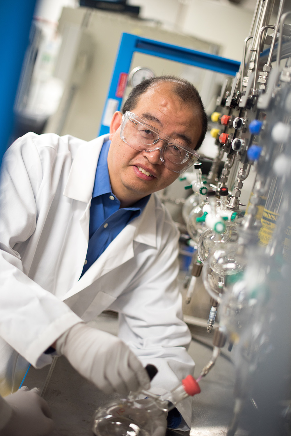 Texas A&amp;M chemist Hongcai Joe Zhou wears lab safety clothing as he works in his lab
