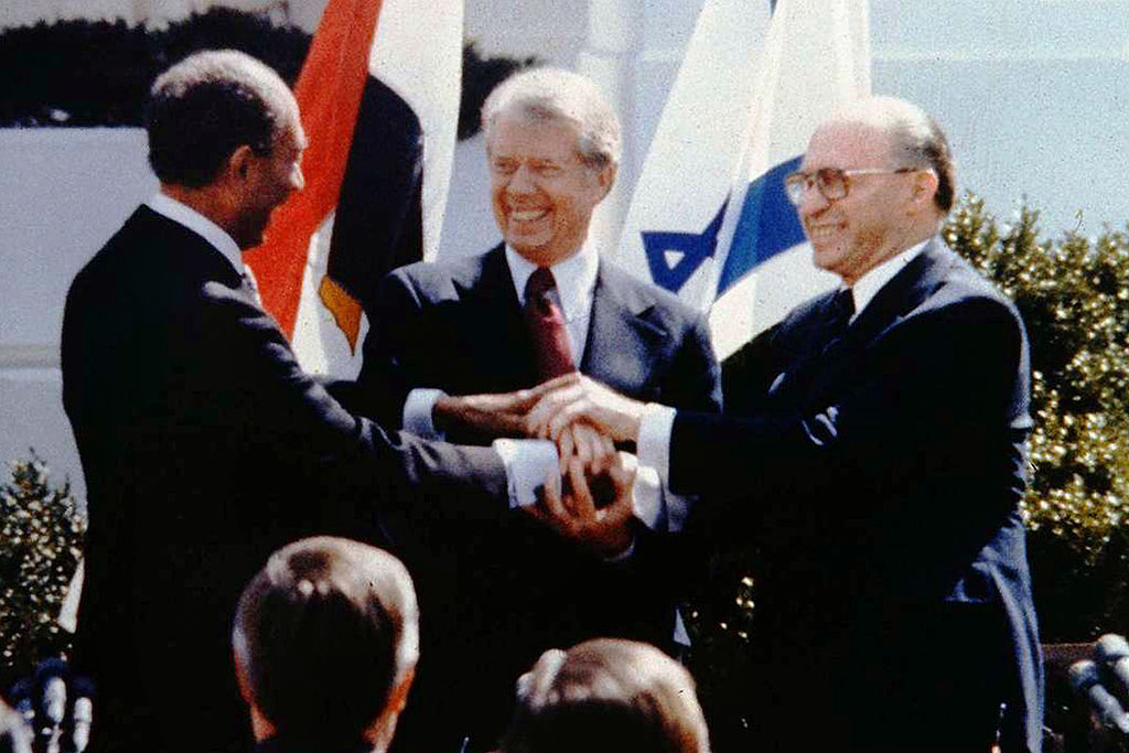 The triple handshake between Egyptian President Anwar Sadat, U.S. President Jimmy Carter and Israeli Prime Minister Menahem Begin sealed the signing of the Israeli-Egyptian peace treaty on March 26, 1979 on the White House lawn.