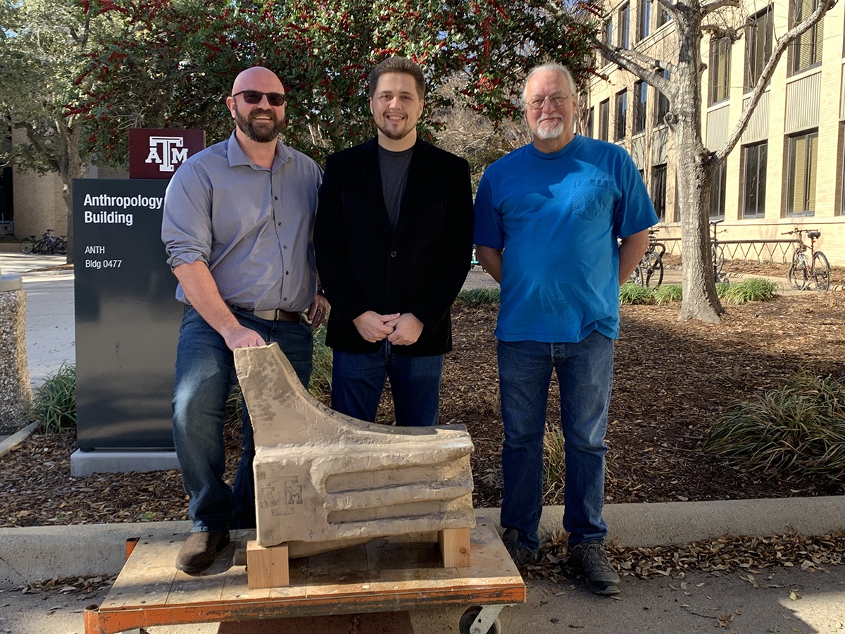 The Texas A&M naval ram project team poses with the ram outside the Anthropology Building on the Texas A&M University campus