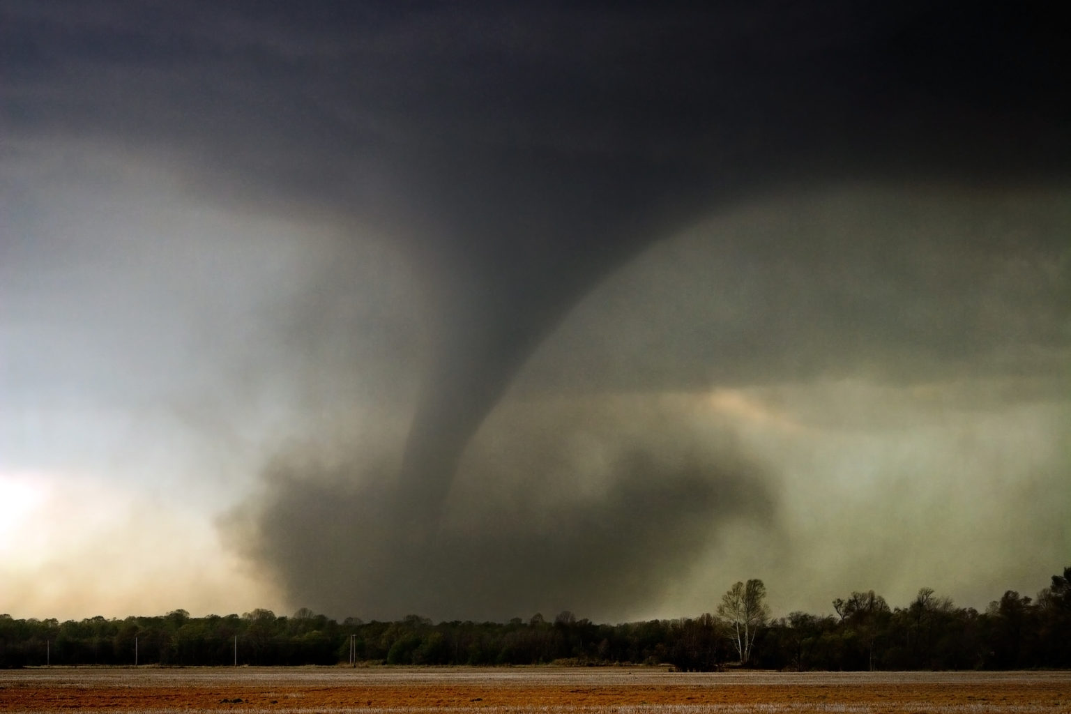 A tornado sweeps across an open field