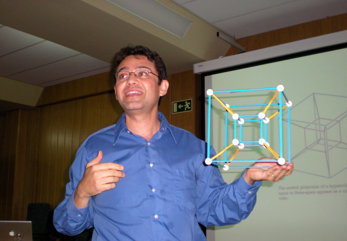University of California, Davis, mathematician Jesus De Loera holds a cube as he presents his research on