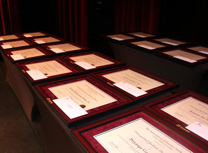 Table displaying Distinguished Graduate Student Awards plaques