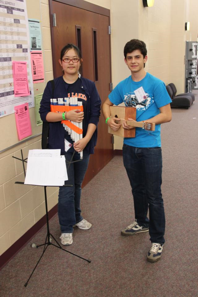 Two students hold handmade musical instruments during Texas Science Olympiad