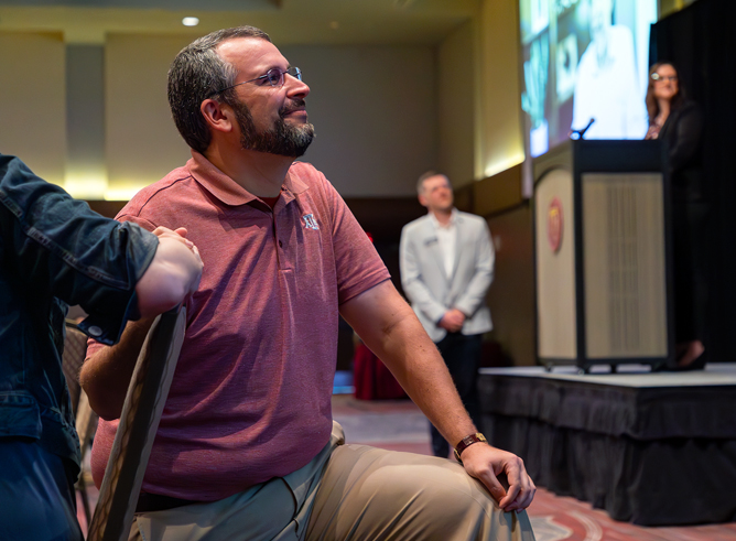 Texas A&amp;M chemist Daniel Collins, holding hands with his fiancé Dr. Sara Fehr while awaiting presentation of his 2023 Outstanding Advocate for First-Year Students Award