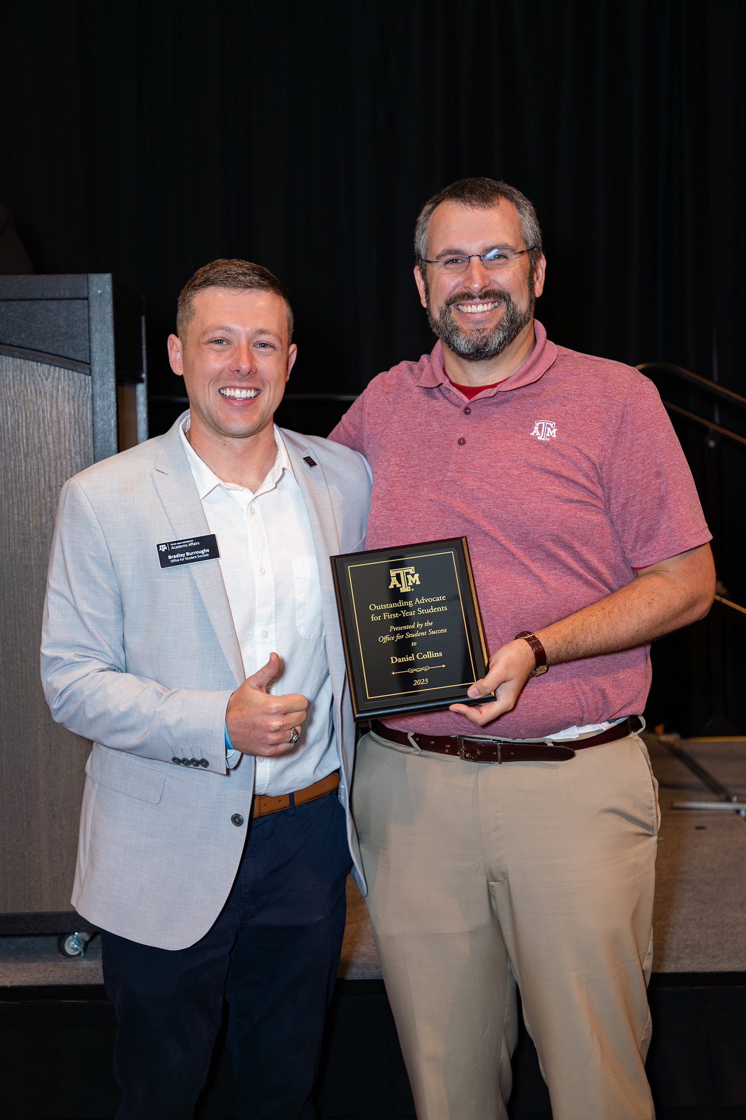 Texas A&amp;M chemist Daniel Collins (right) receives congratulations from the Office for Student Success's Bradley Burroughs upon Collins' receipt of the 2023 Outstanding Advocate for First-Year Students Award