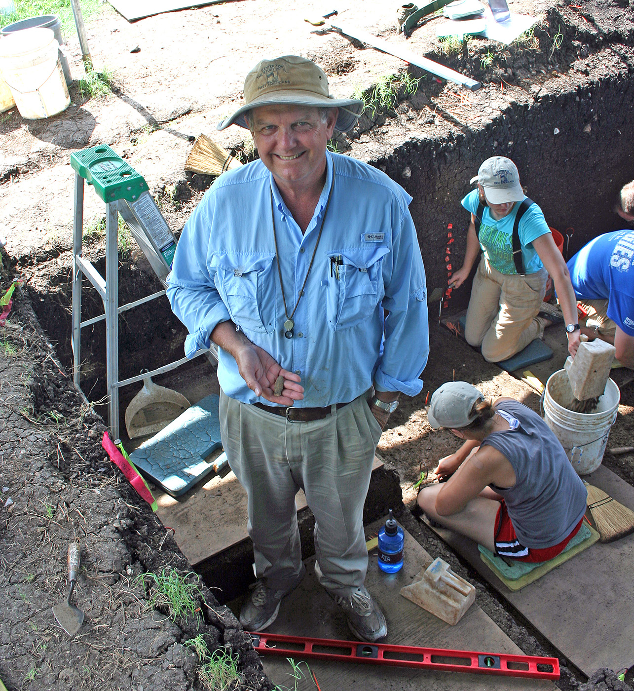 Texas A&amp;M archaeologist Michael Waters holds a complete spear point that he had just found while on a dig in central Texas