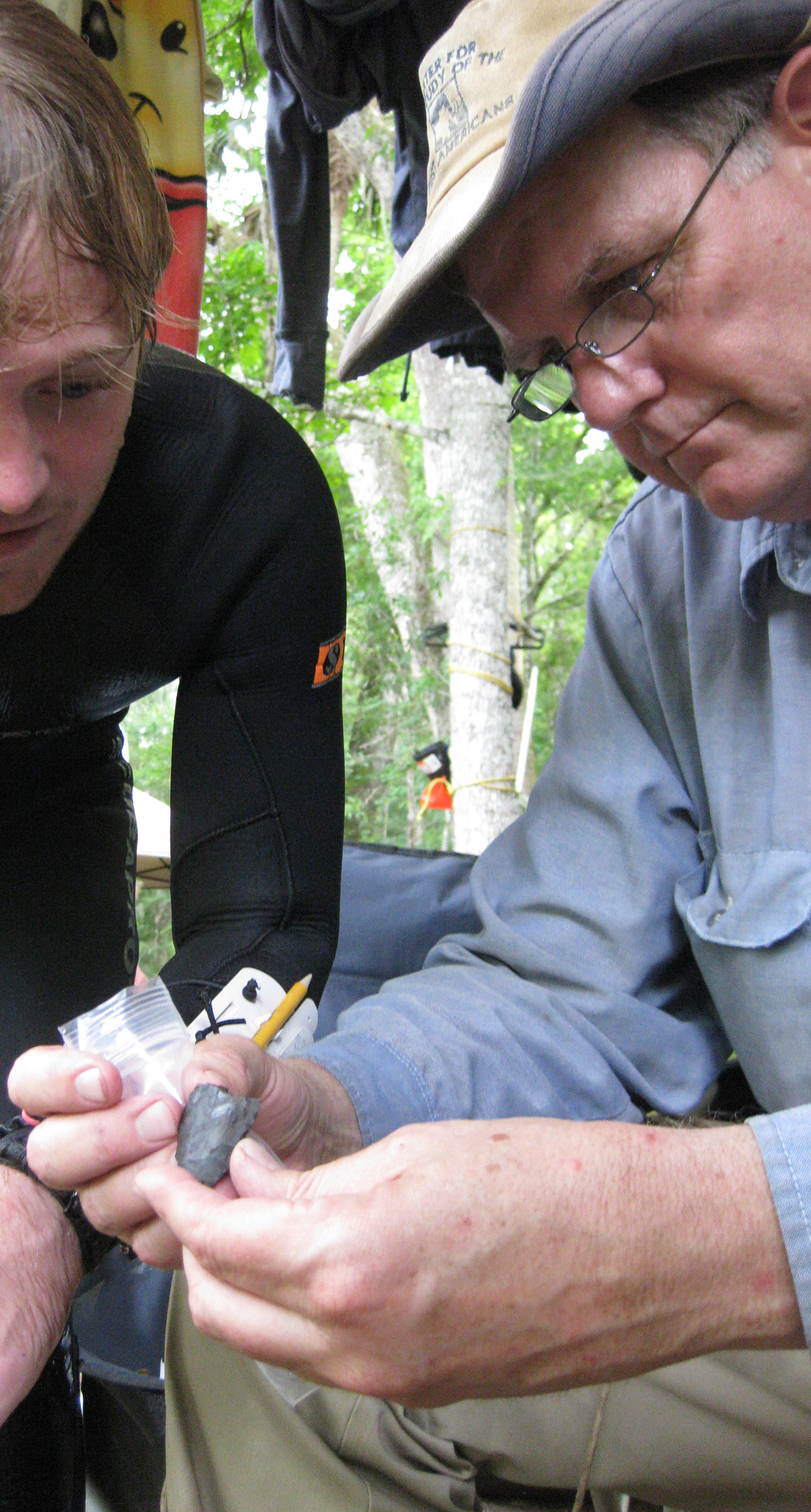 Texas A&amp;M archaeologist Michael Waters and graduate student Morgan Smith examine a 14,600-year-old knife found at the Page-Ladson site in Florida
