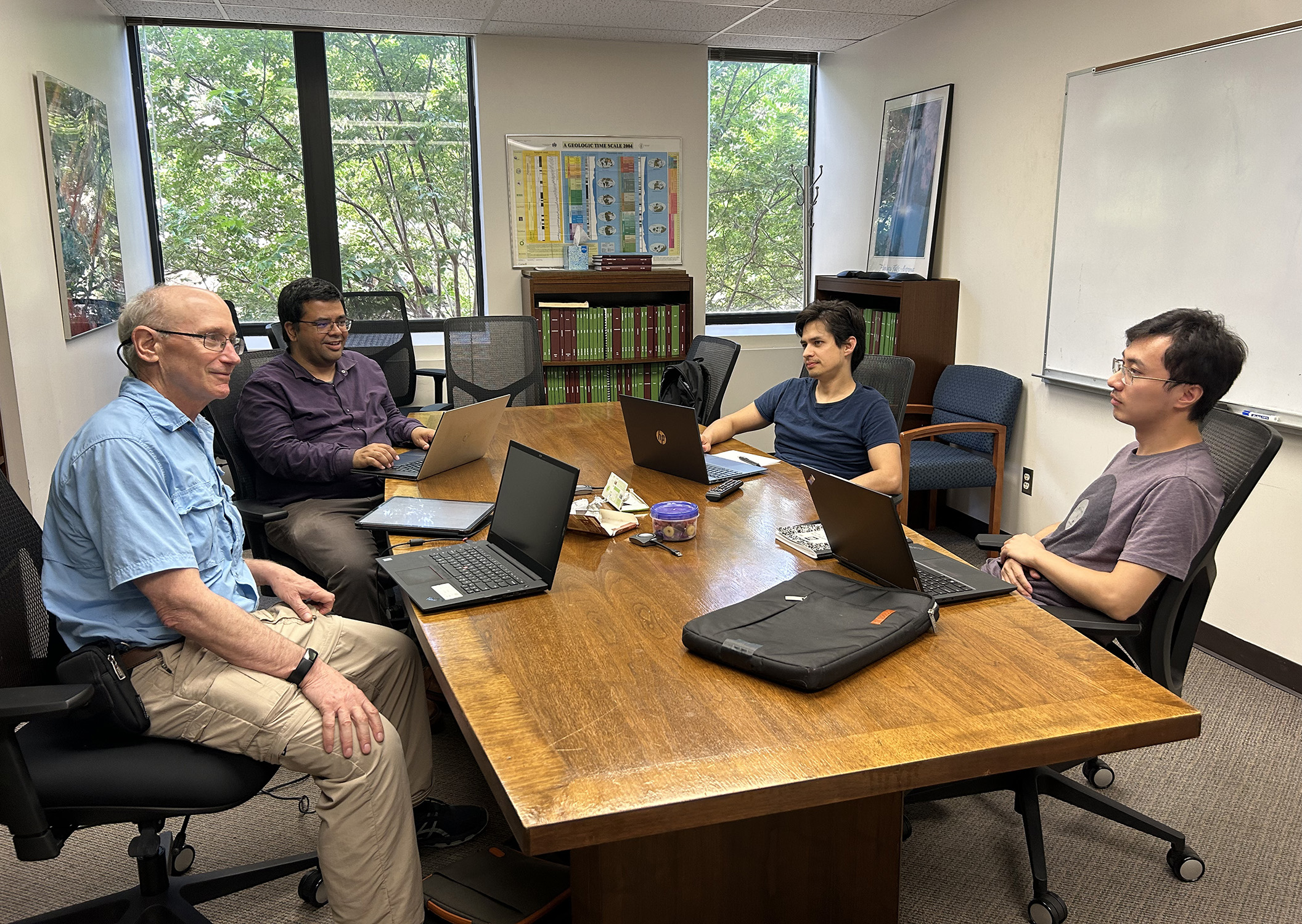 Texas A&amp;M scientists Dr. Ethan Grossman, Dr. Sarbajit Banerjee, Dr. Saul Perez-Beltran and Zeyang Sun sit at a conference table, discussing next steps in their research