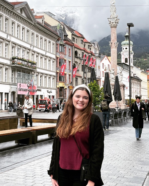 Texas A&amp;M meteorology student Hope Boland smiles for the camera on a street corner in Munich, Germany
