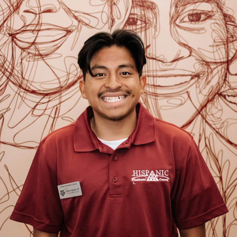 Texas A&amp;M psychology major Daniel Salazar poses in front of the Multicultural Services mural in the Memorial Student Center on the Texas A&amp;M University campus