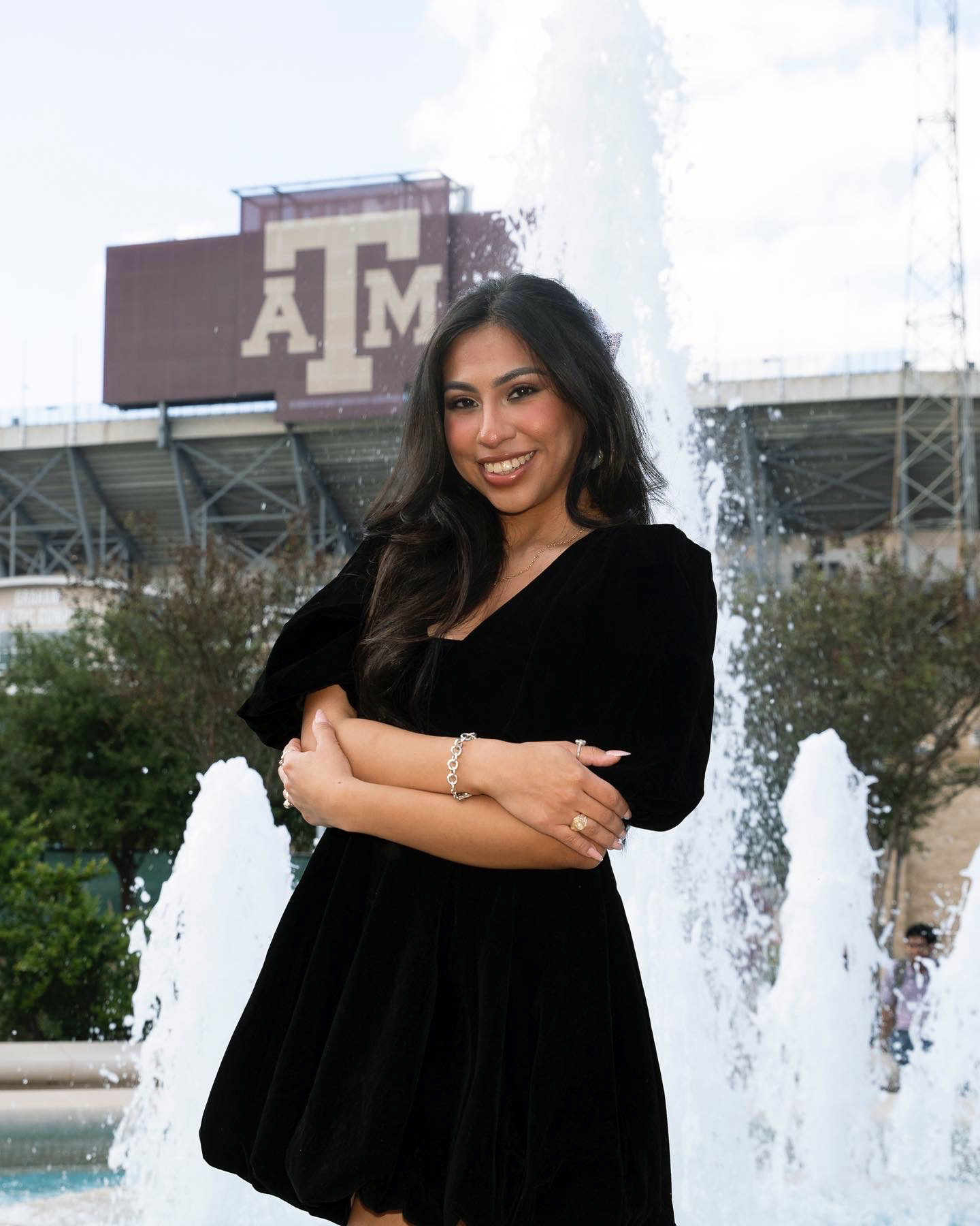 Texas A&amp;M women's and gender studies major Odyssey Olmos poses after receiving her Aggie Ring with the jumbotron at Kyle Field in the background