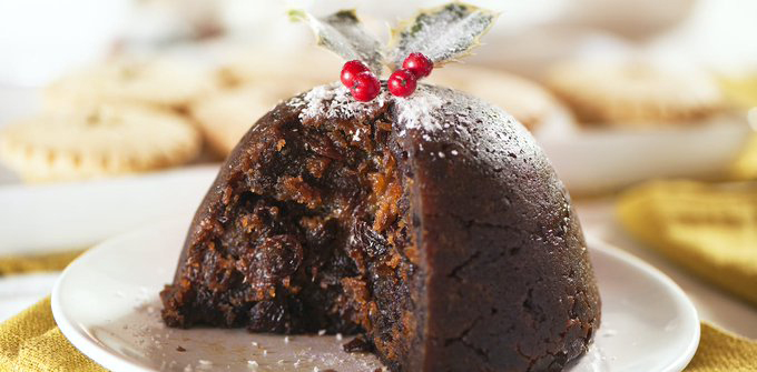 Stock image of Christmas pudding, served on a small white ceramic plate