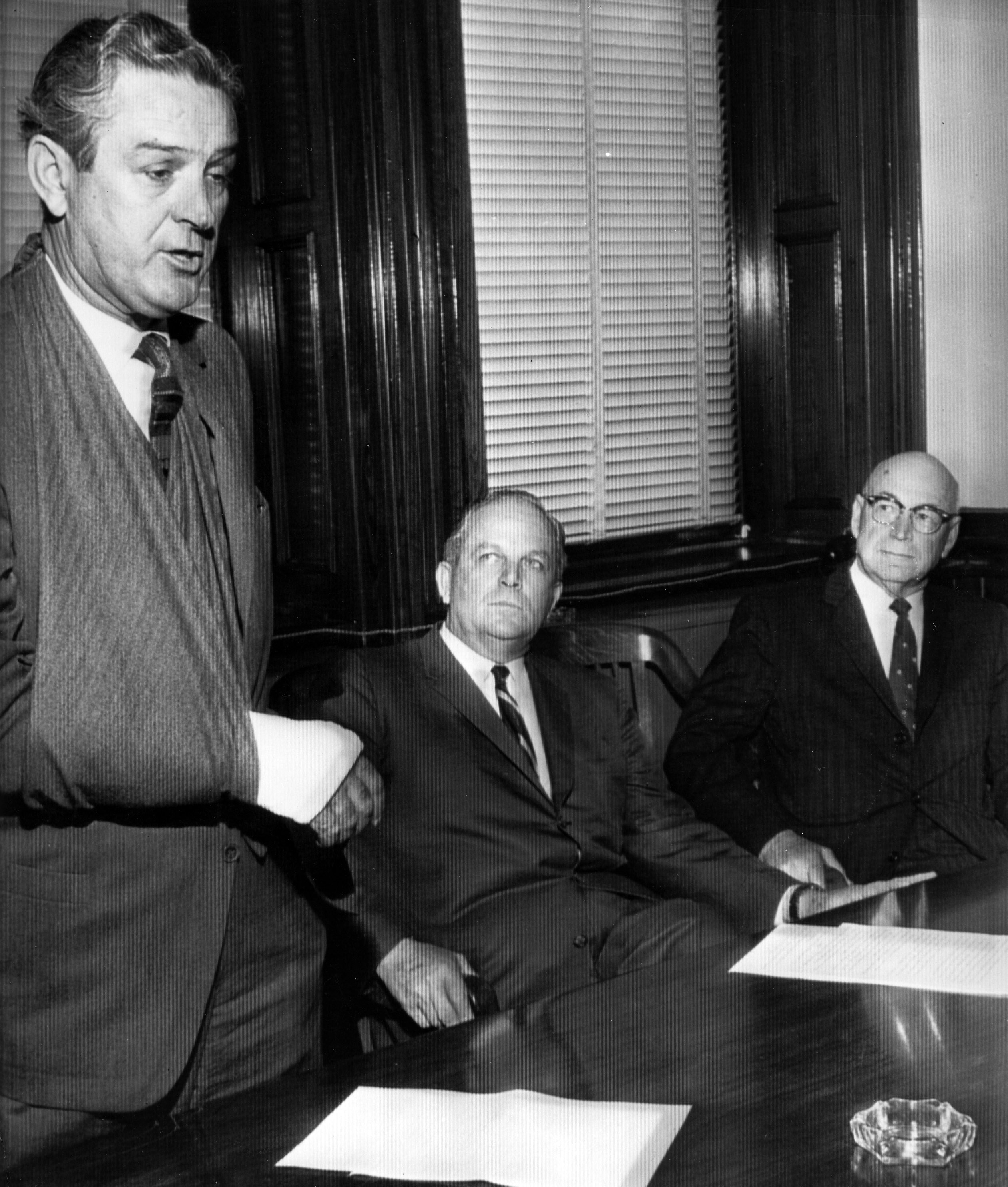 Black and white of Governor John Connally, James Earl Rudder and Sterling C. Evans around a conference table