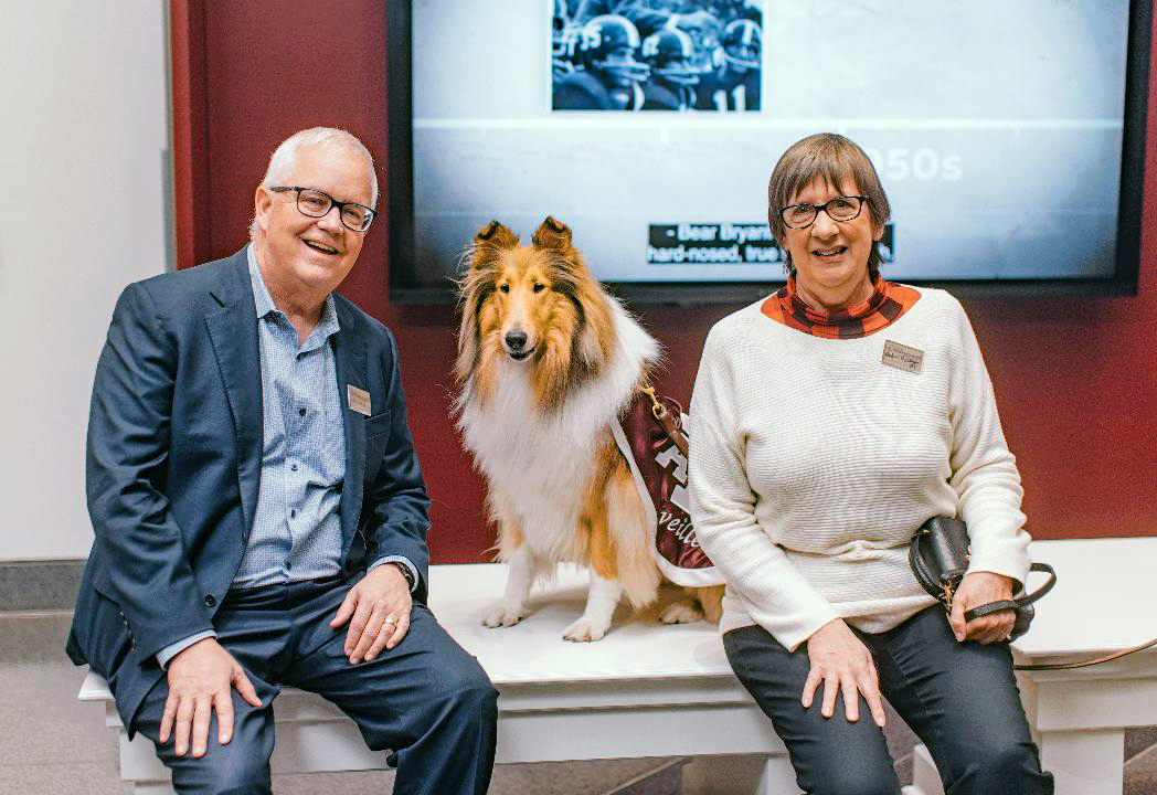 Texas A&M University former students Michael and Debra Dishberger pose with Texas A&M mascot Reveille