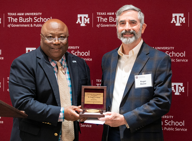 Texas A&amp;M University history professor Roger Reese accepts his award from Bush School Interim Dean Dr. Frank Ashley