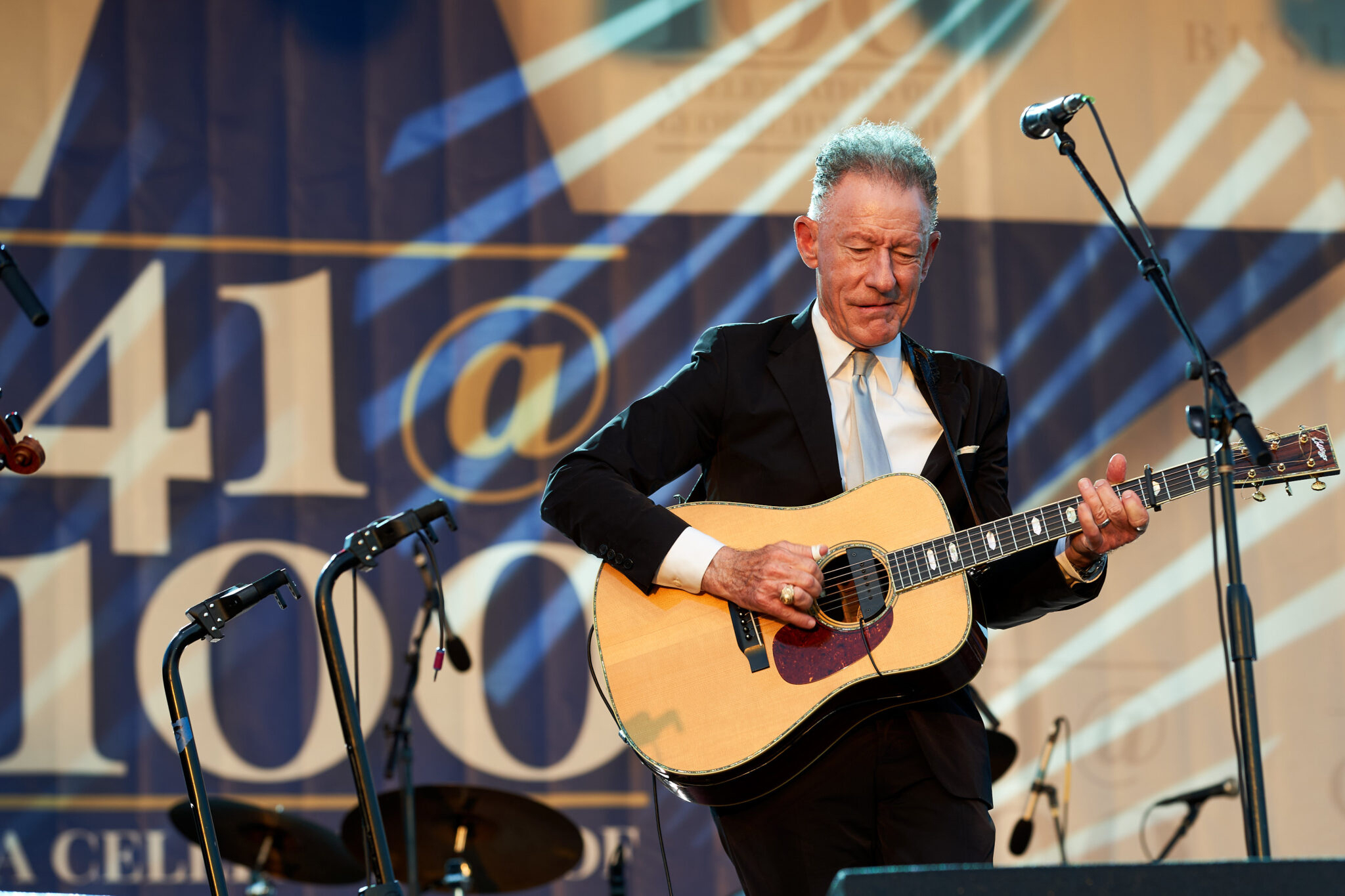 Close up of Texas A&amp;M University former student and musician Lyle Lovett performing on stage on the grounds of the George H.W. Bush Presidential Library and Museum during the Bush 41@100 Centennial Celebration on June 13, 2024