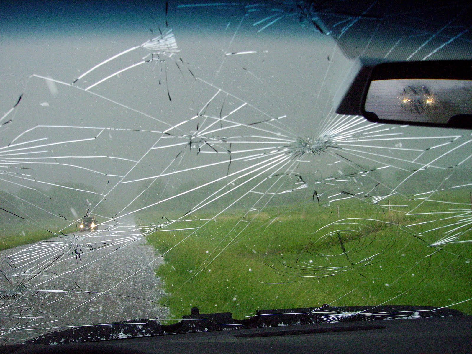 Stormy skies viewed through the cracked windshield of a mobile mesonet vehicle driven by Texas A&amp;M University atmospheric scientist Christopher Nowotarski during the VORTEX2 field project in June 2009 in eastern Wyoming