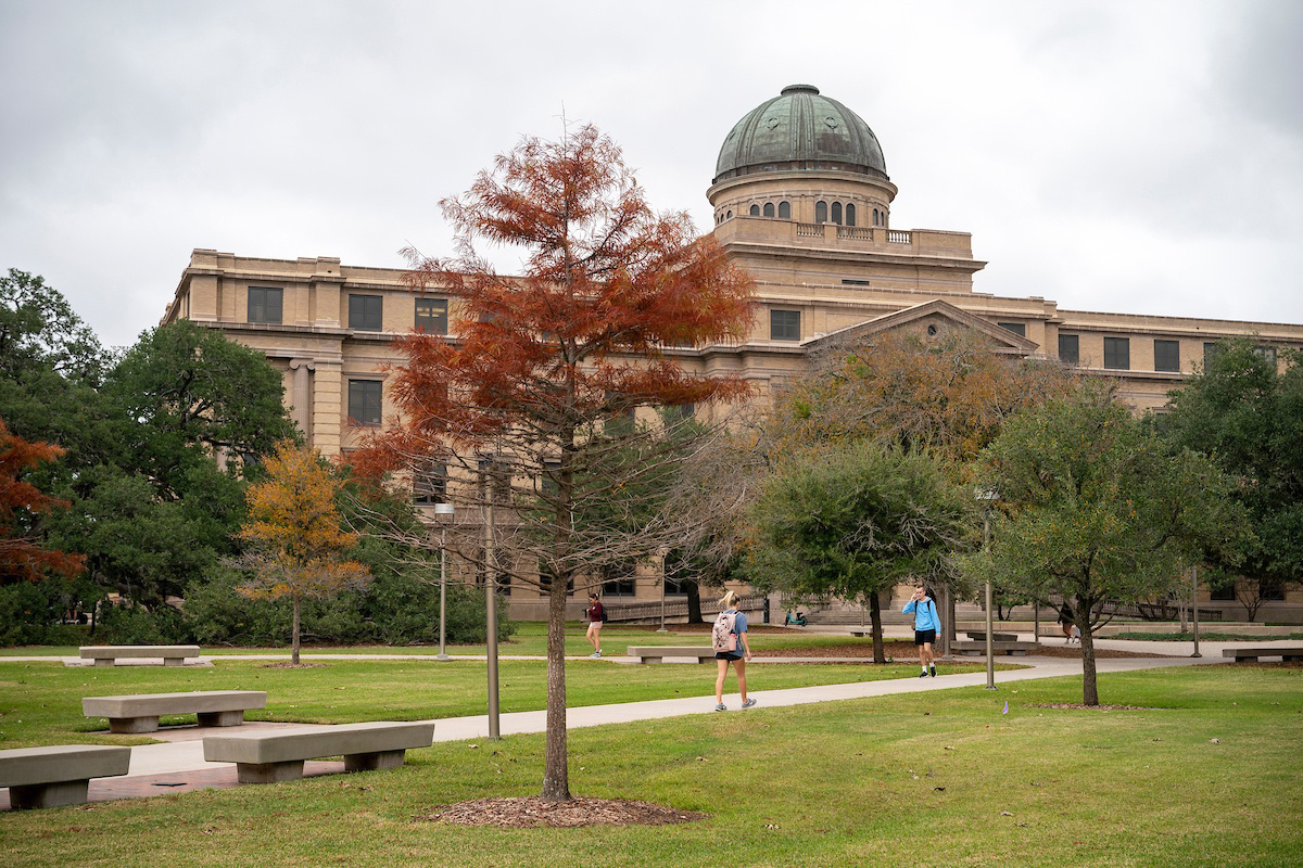 Front view of the Academic Building featuring fall foliage on the Texas A&amp;M University campus