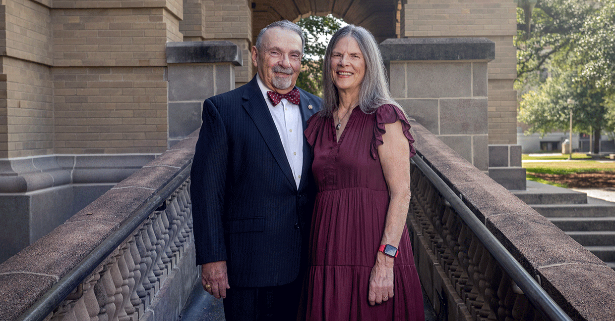 1970 Texas A&M University physics graduate R. Bowen Loftin and his wife, Karin, pose in front of the Academic Building on the Texas A&M campus