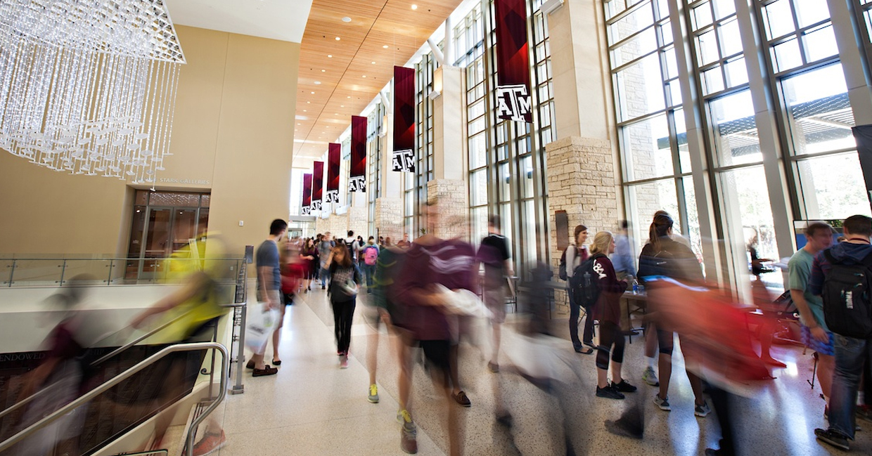 Stop motion image of student traffic in the main hallway of the Memorial Student Center on the Texas A&amp;M University campus