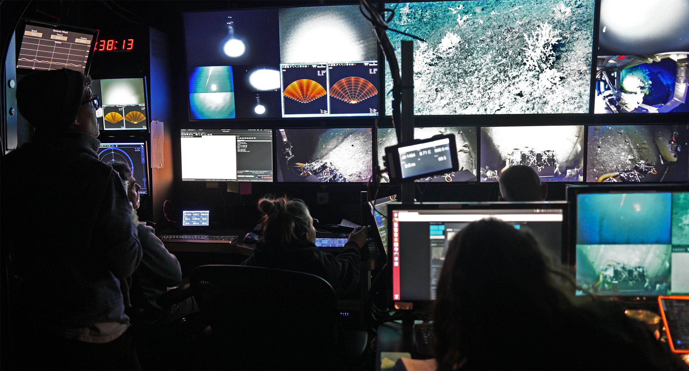 Alyssa Schultz serves as Watch Lead in the ROV Jason control van aboard the R/V Kilo Moana during a recent research cruise to the Hawaiian Islands, where she coordinated with pilots and engineers to collect deep-sea coral samples for her dissertation.