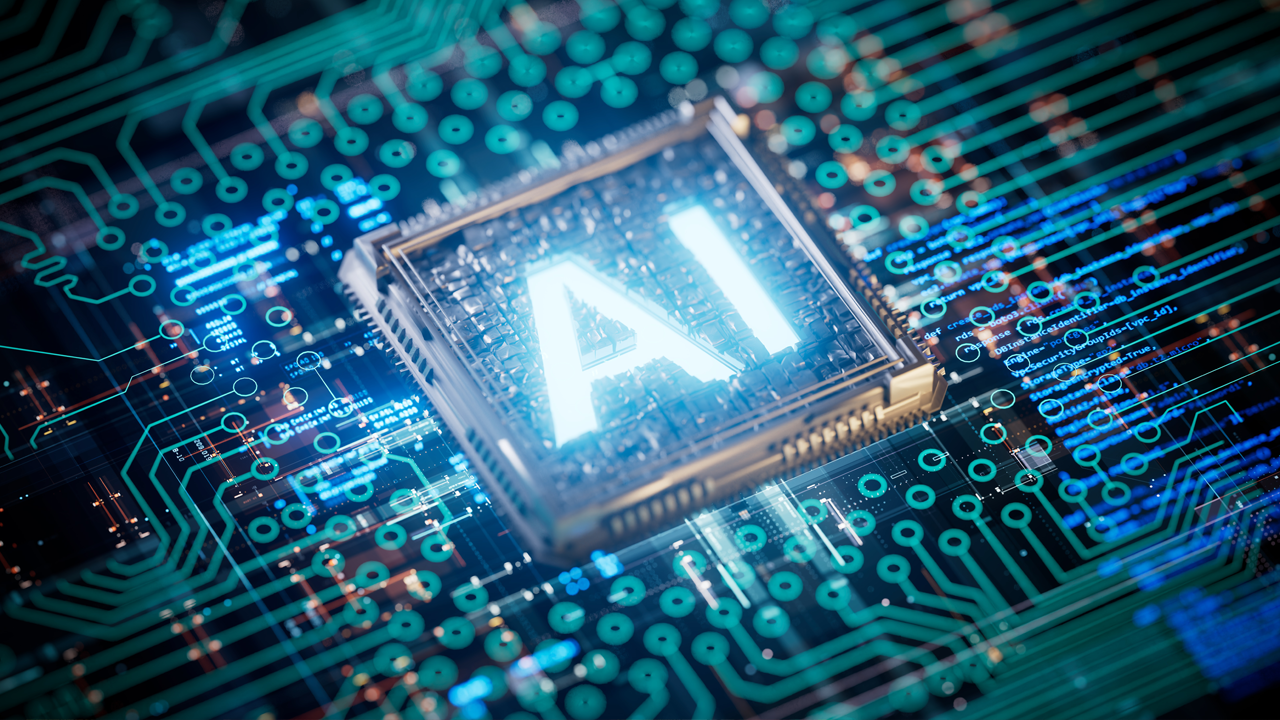 A close-up image of a microchip with the letters "AI" illuminated at the center, set against a background of a detailed circuit board.