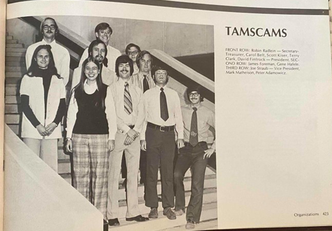 Group photo of eleven members of the TAMSCAMS organization on a staircase, with names of the visible people listed, including Robin Reskin and David Formánek. The photo is from the Texas A&amp;M 1974 Yearbook.