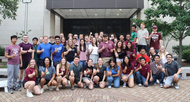 A group of TAMSCAMS students standing in front of the Oceanography and Meteorology building at Texas A&amp;M University. The photo is from May 2024