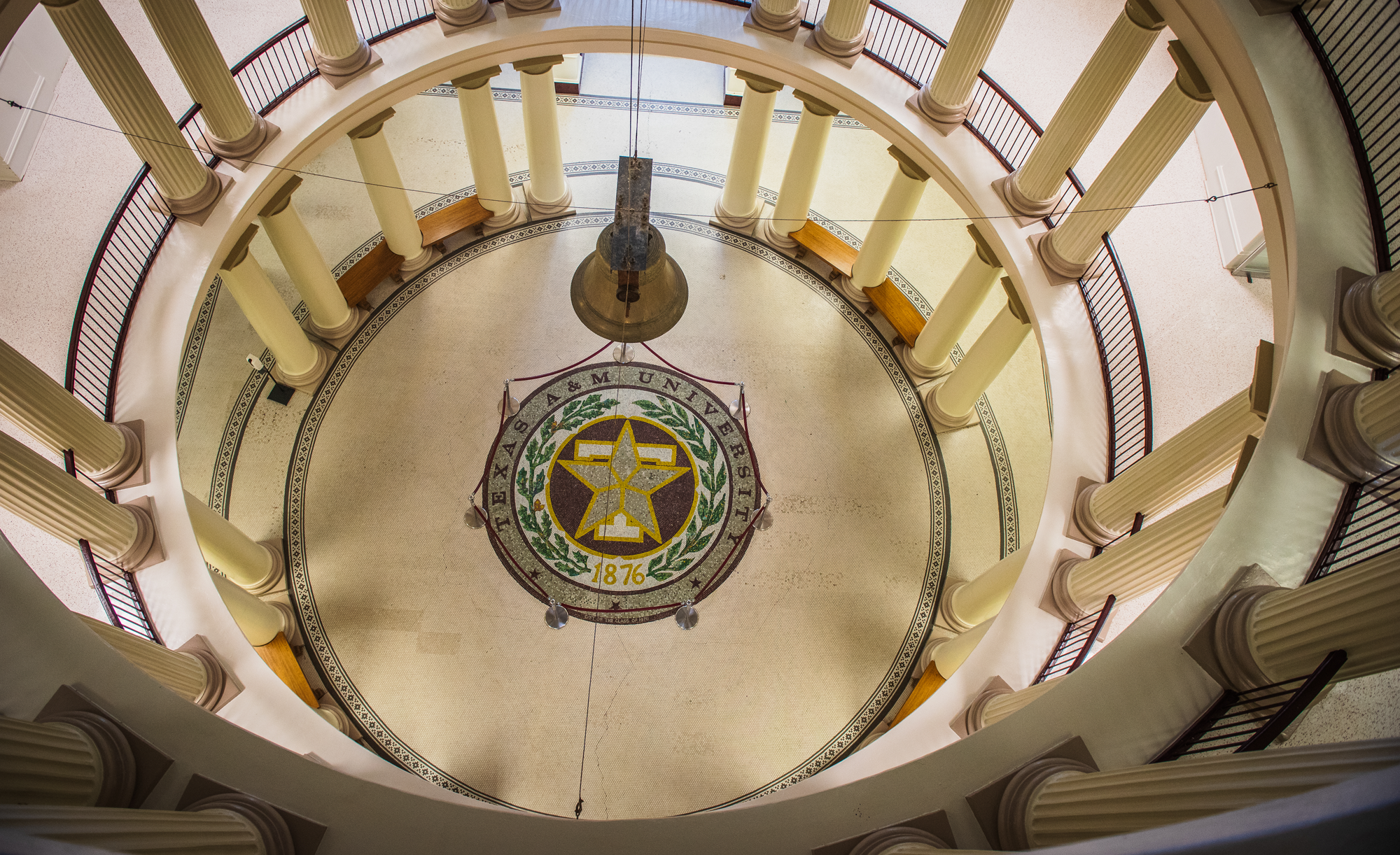 Overhead view of a rotunda floor with Texas A&M University seal, surrounded by columns.