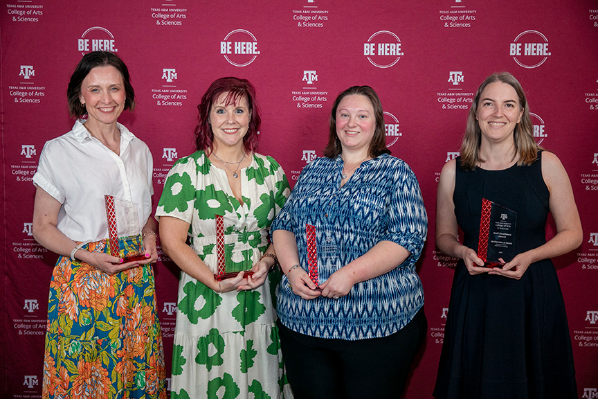 Four award recipients holding trophies, standing in front of a Texas A&M University College of Arts & Sciences backdrop.