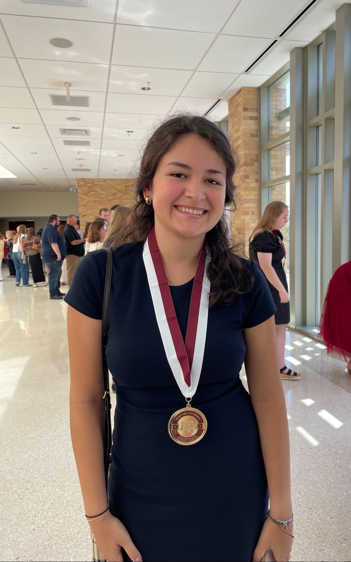Daniela poses inside the MSC with a medal around her neck.